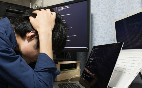 Stressed Asian engineer  put his hands on his head