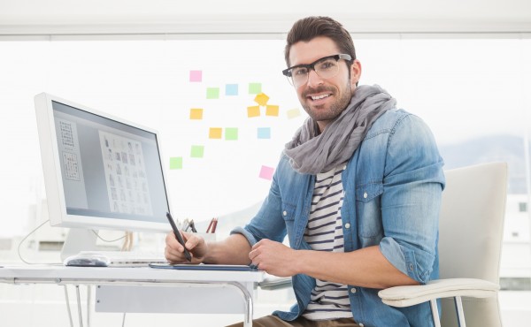 Portrait of happy designer using digitizer in the office