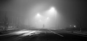 Black and white street at night with heavy fog