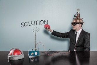 Solution concept with businessman holding brain