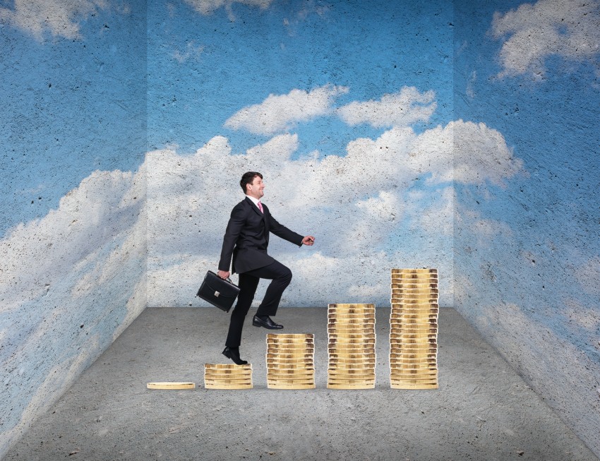 Businessman holding briefcase climbing on coins stack to success in rough room