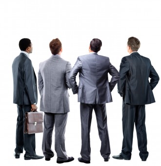 four business mans from the back - looking at something over a white background